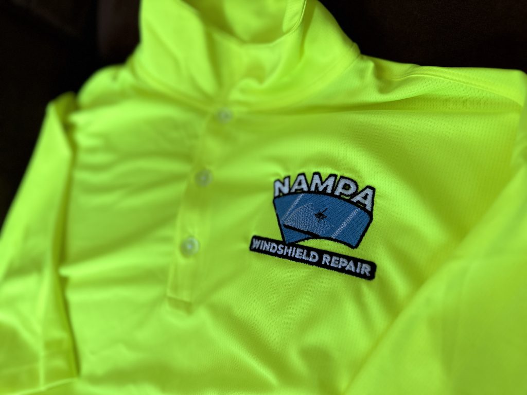 Embroidered logo on a safety yellow polo for a windshield repair company in Idaho.