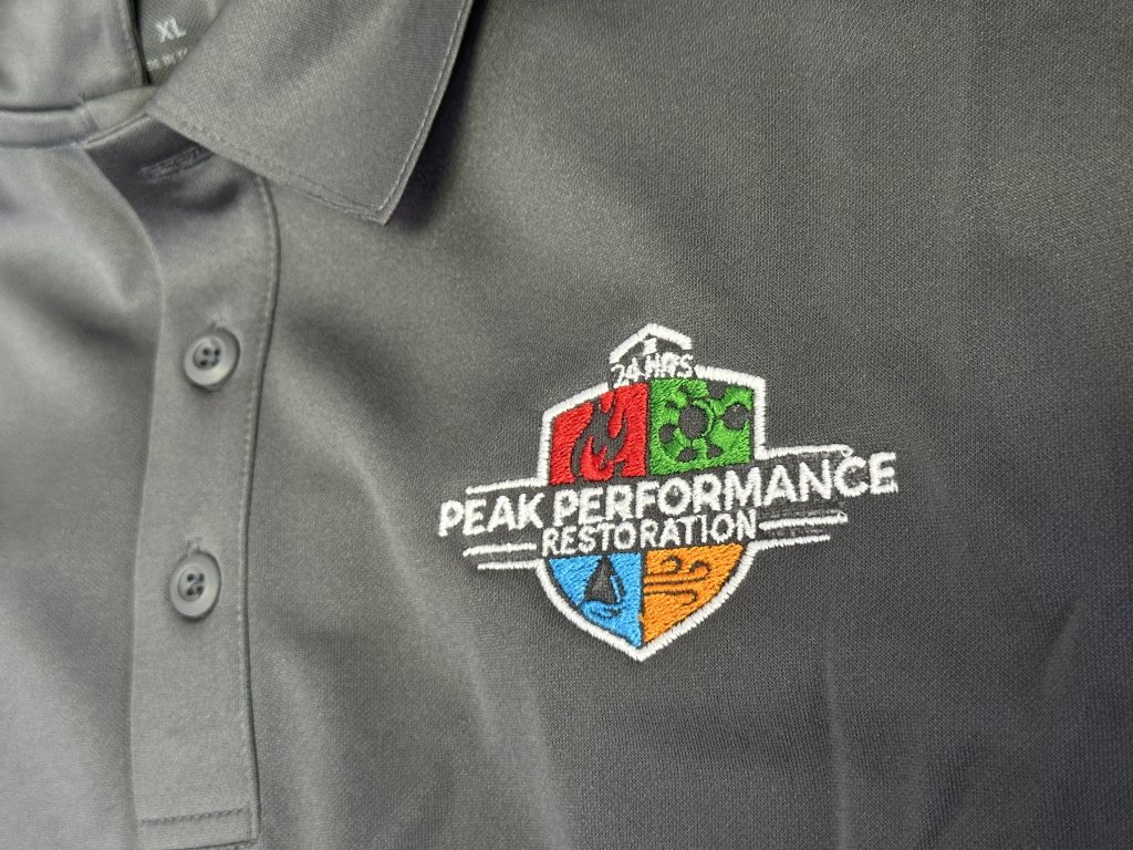5-color embroidery logo on a poly-synthetic blend polo for a local Restoration Company in Nampa.