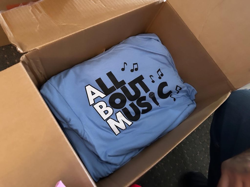 Bulk custom screen printed t-shirts created at The Print Plug for a regional musician