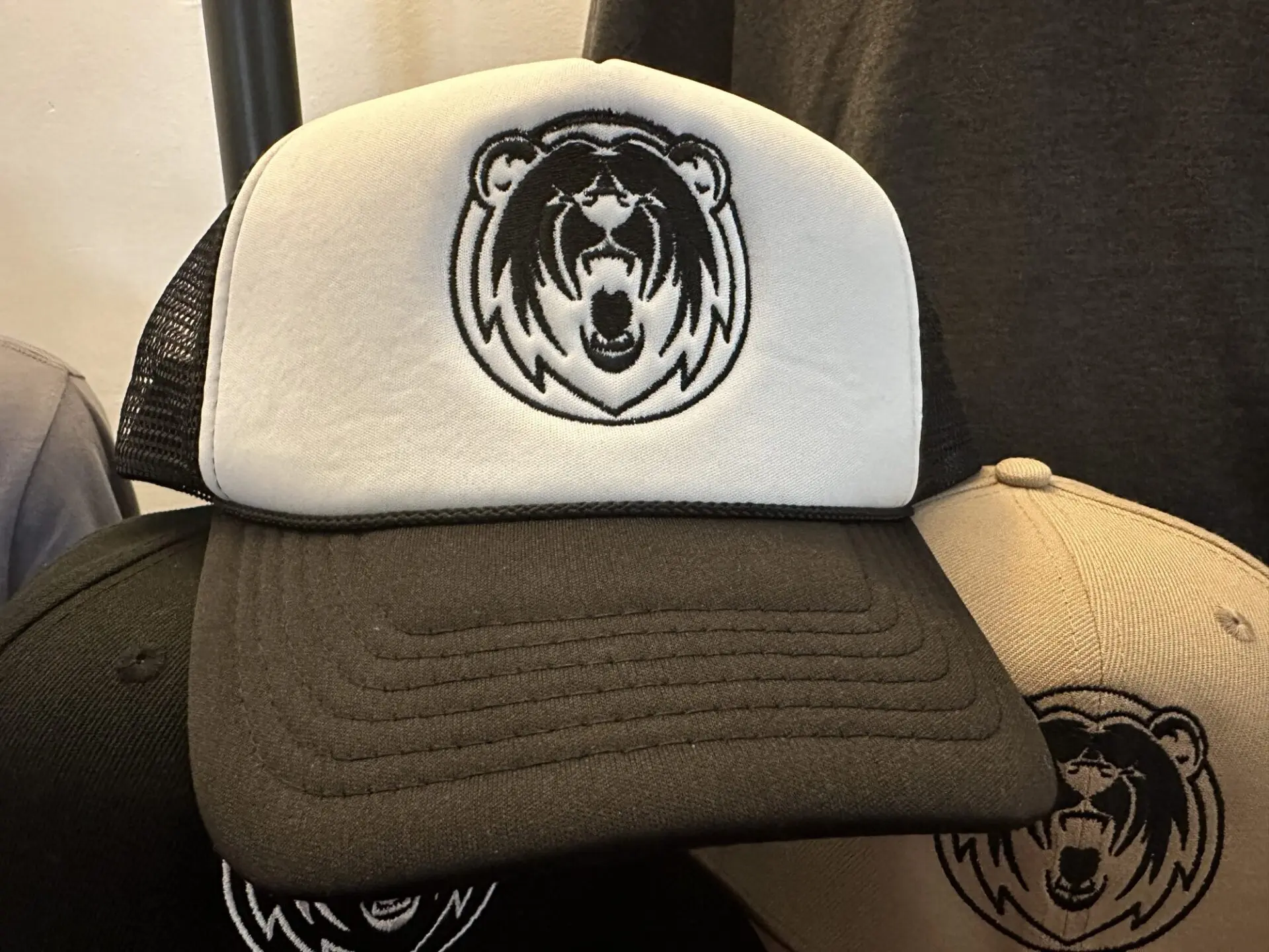 Custom single color logo embroidery on a baseball cap for a tattoo shop