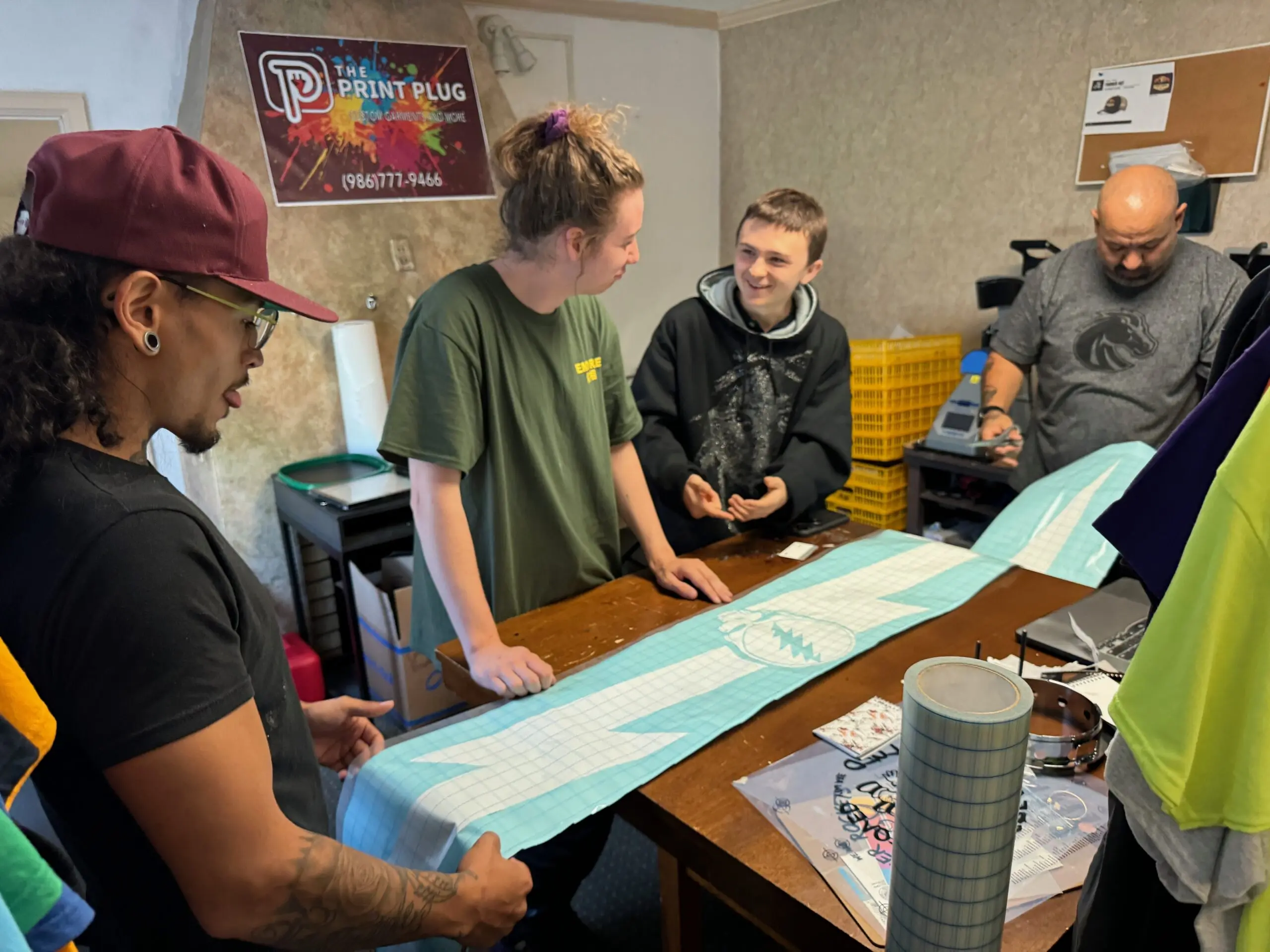 The Print Plug team looking at a large format wall decal in Nampa
