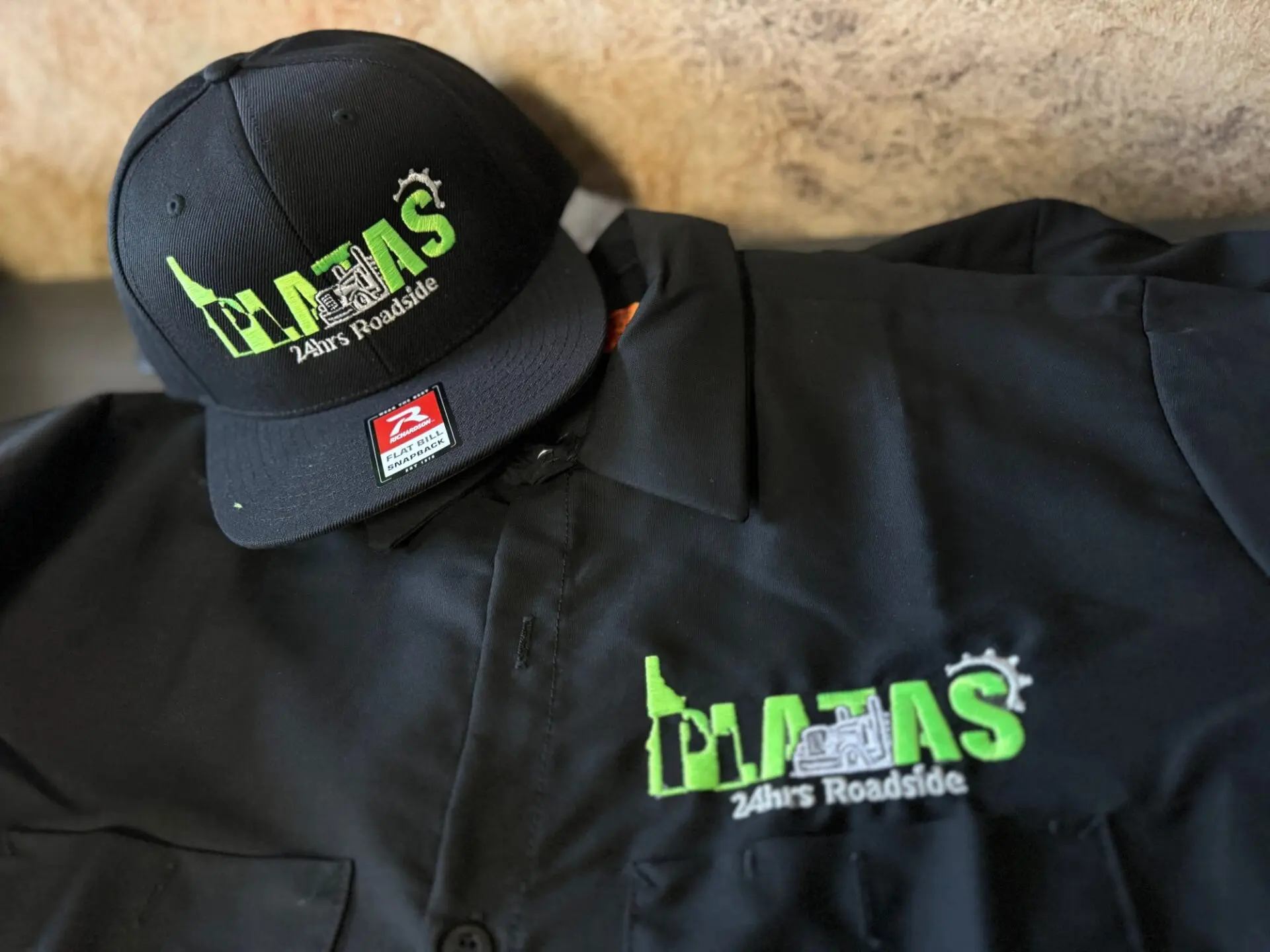 Custom embroidered hats and a custom embroidered shirt from The Print Plug in Nampa
