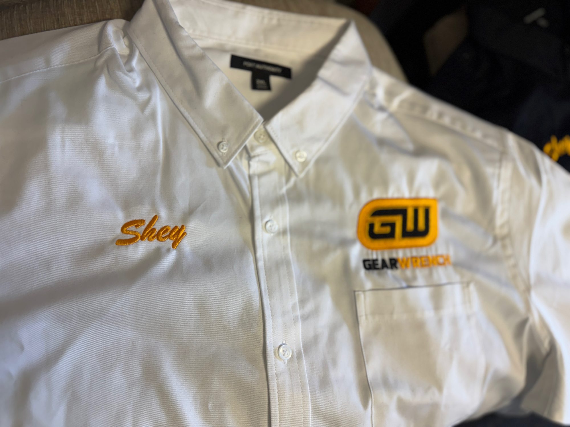Custom embroidered shirt button-up with logo embroidered over pocket and opposite