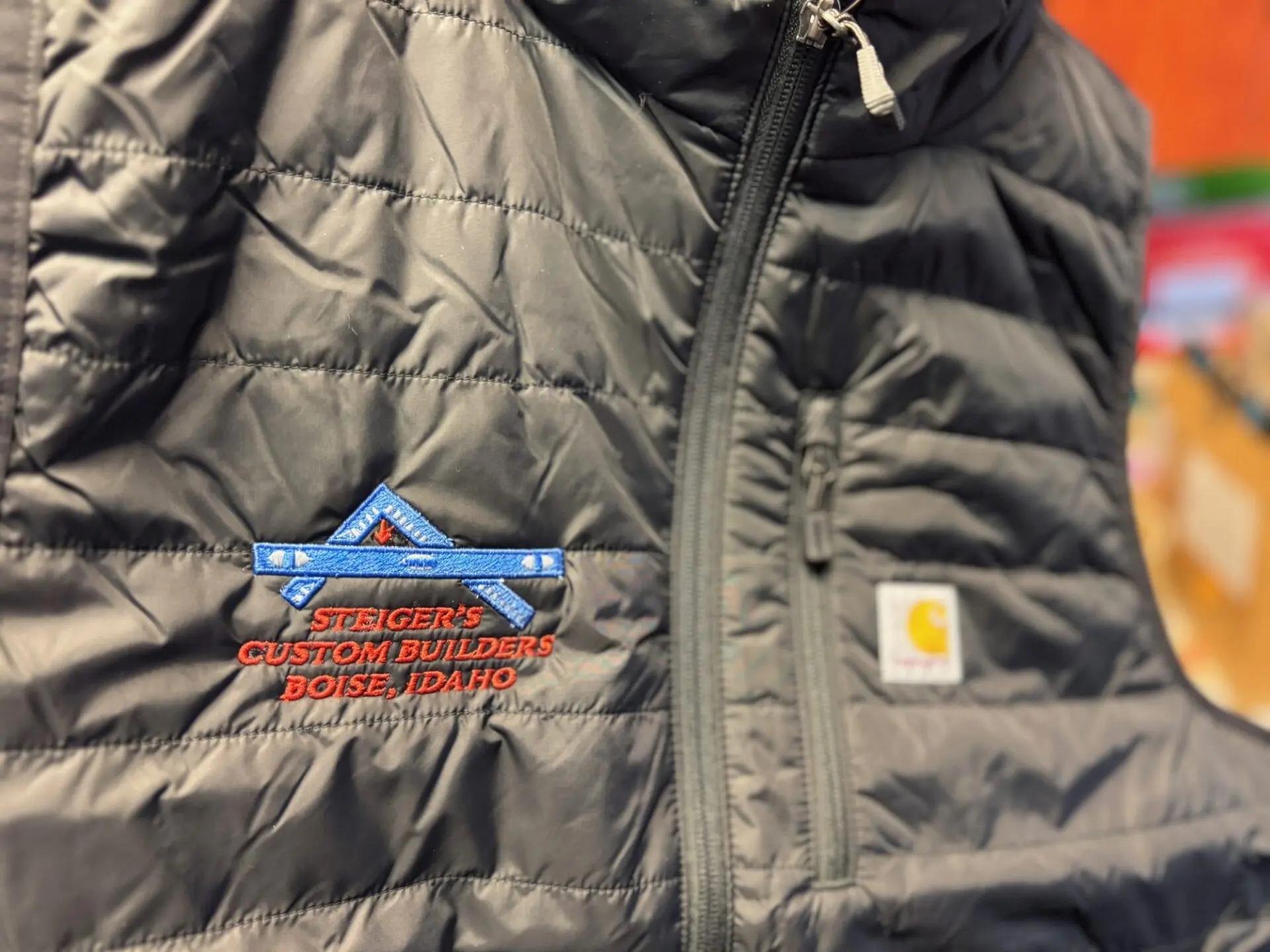 Custom embroidered vest with fine detail in logo from The Print Plug embroidery shop in Nampa