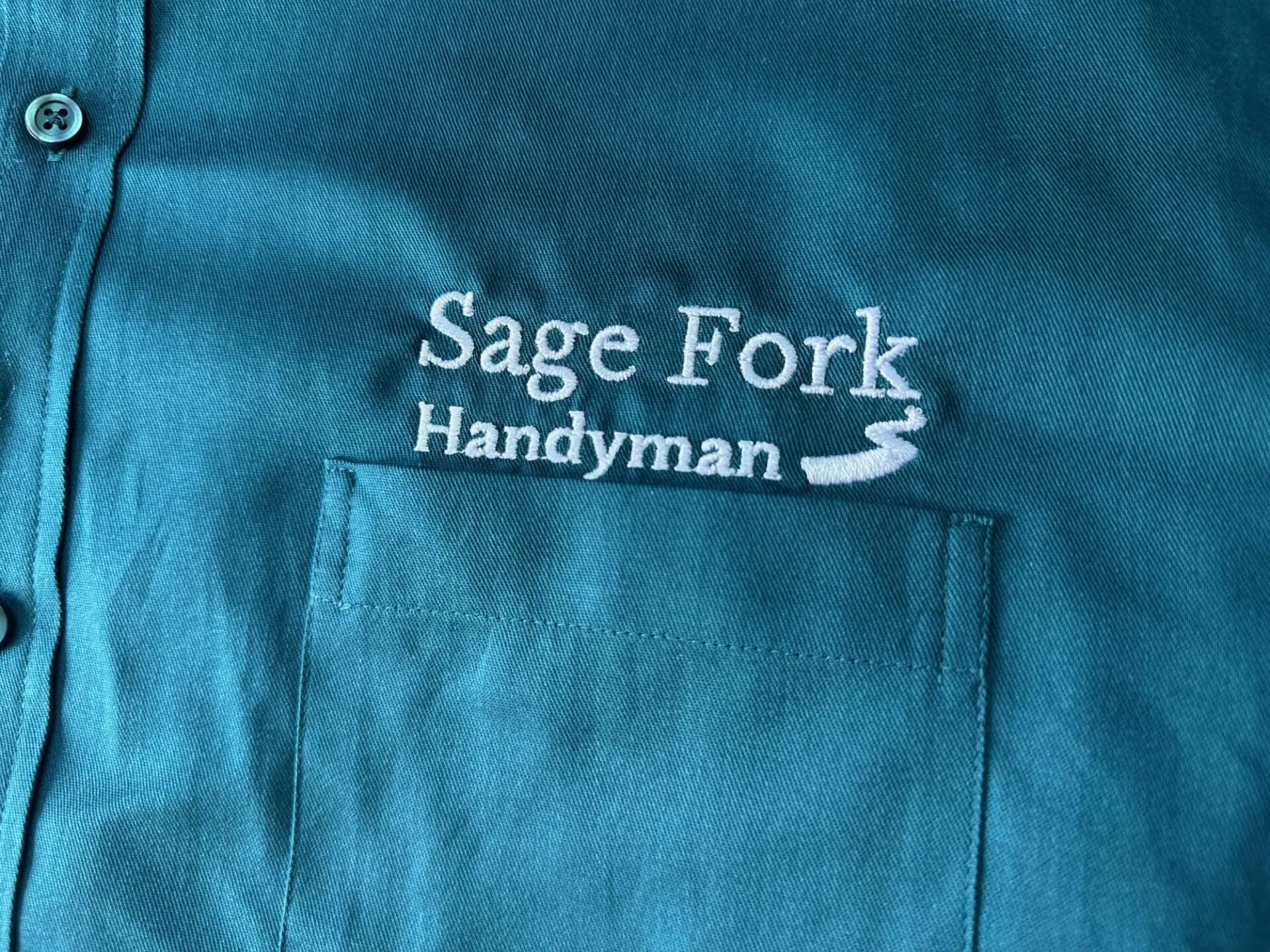 Custom embroidered button-up shirt with logo embroidery over the pocket