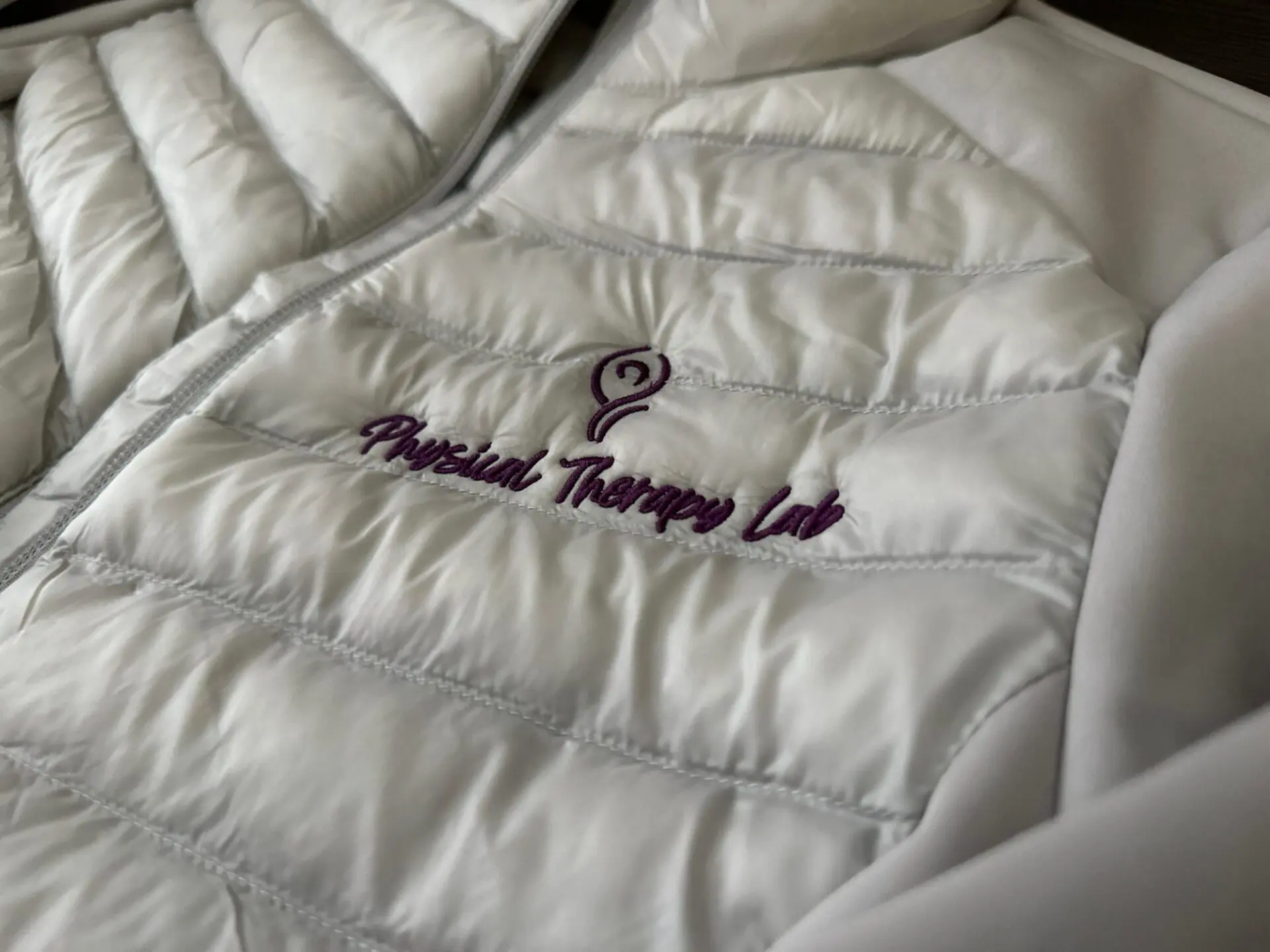 Custom embroidered jacket with company logo embroidered on the left chest
