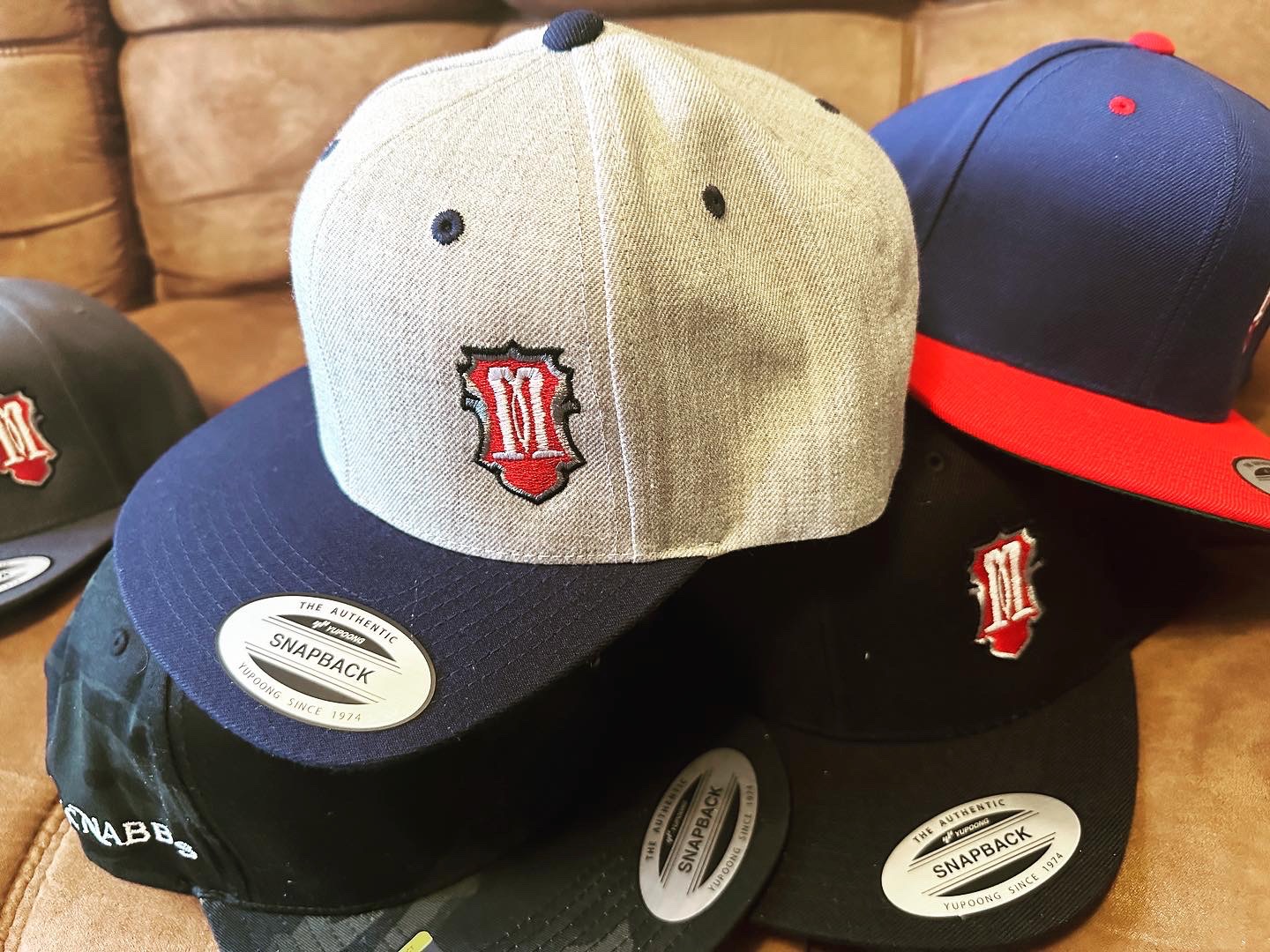 Custom embroidered hats for a local tattoo company near Nampa from The Print Plug