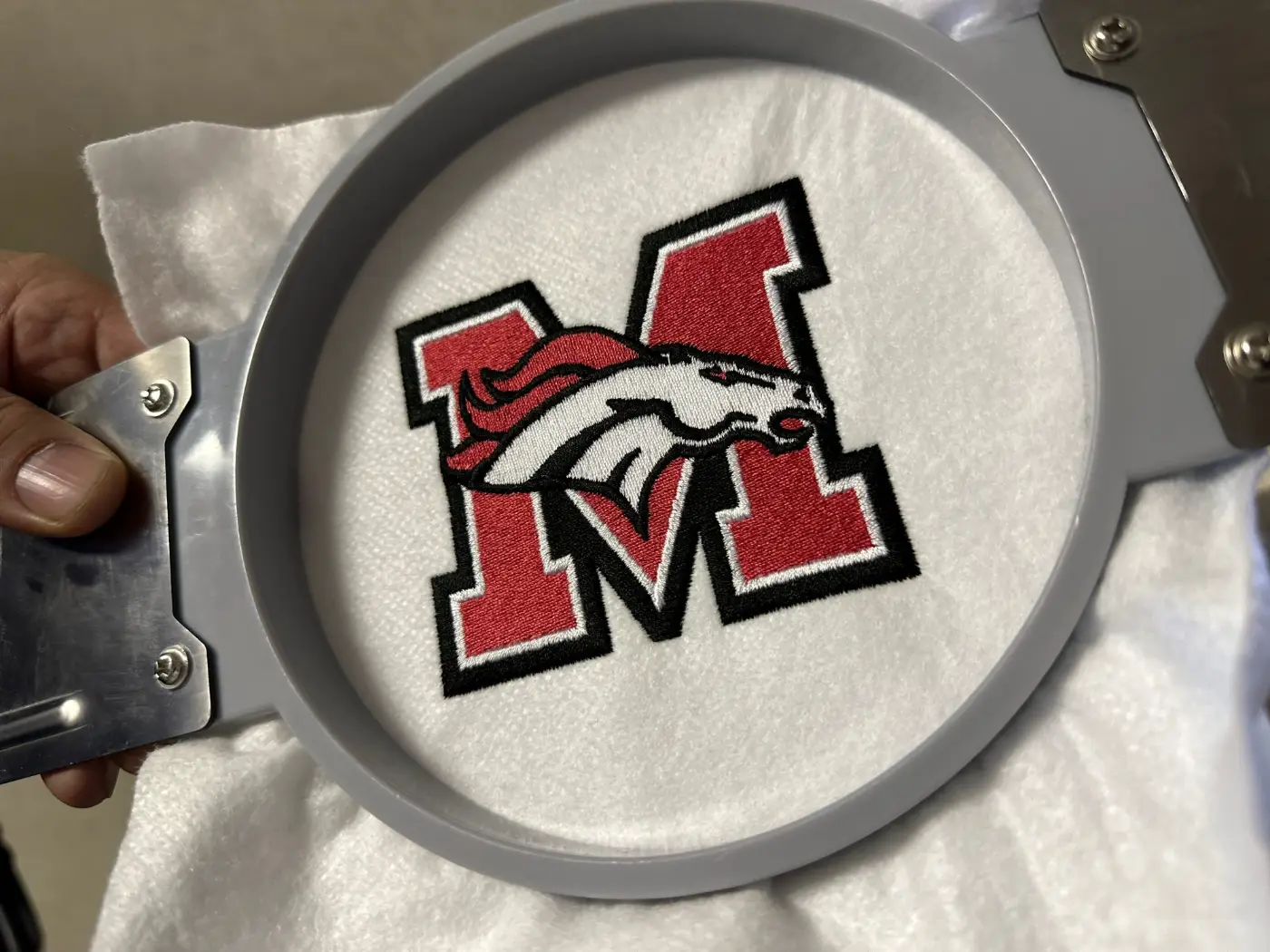 School logo embroidered on a hoop