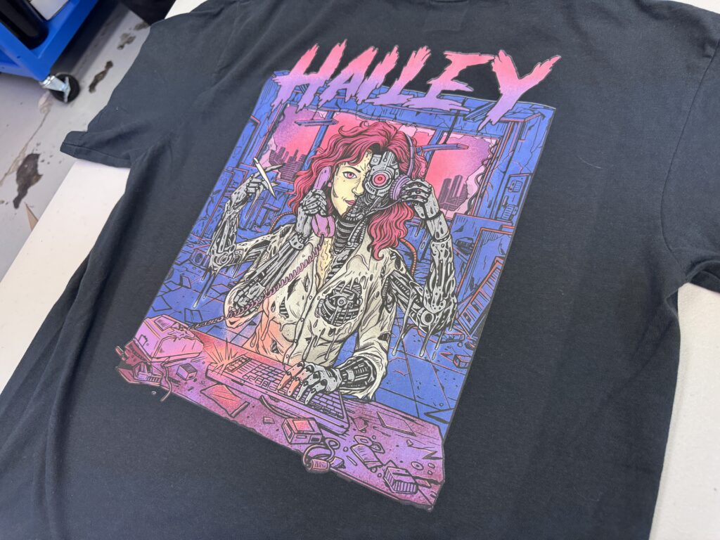 Close up a DTF printed graphic on a dark t-shirt showing bright and vivid colors