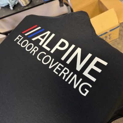 Custom white-on-black screen printed shirts at The Print Plug custom t-shirt shop in Nampa, Idaho
