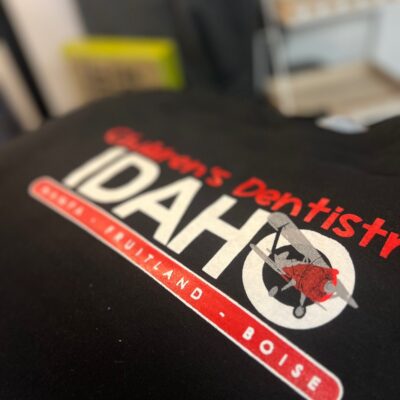 Customized screen printed shirts with company logo on the front at The Print Plug in Nampa