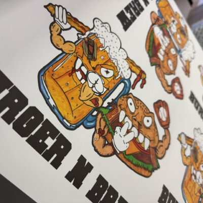 Close up of a DTF gang sheet with graphics for local restaurant