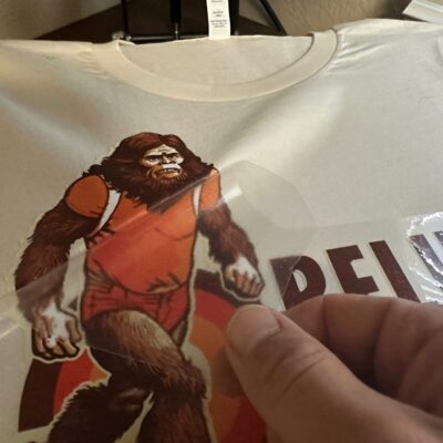 Applying an HTV print onto a custom t-shirt at The Print Plug in Nampa