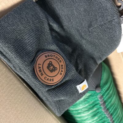 Custom leather patch on a beanie for a local business in Nampa
