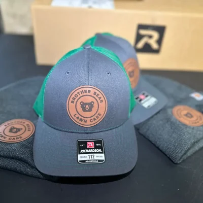 Custom faux leather patches pressed on hats near Boise